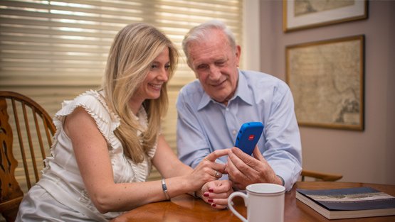 Senior couple holding mobile phone