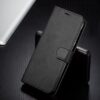 A sleek black wallet phone case standing on a table, showcasing its elegant design.